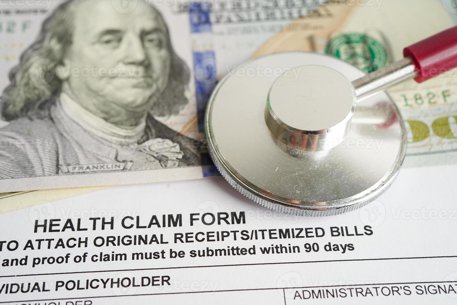 Health claim form with stethoscope and US dollar banknotes, insurance accident medical concept. photo