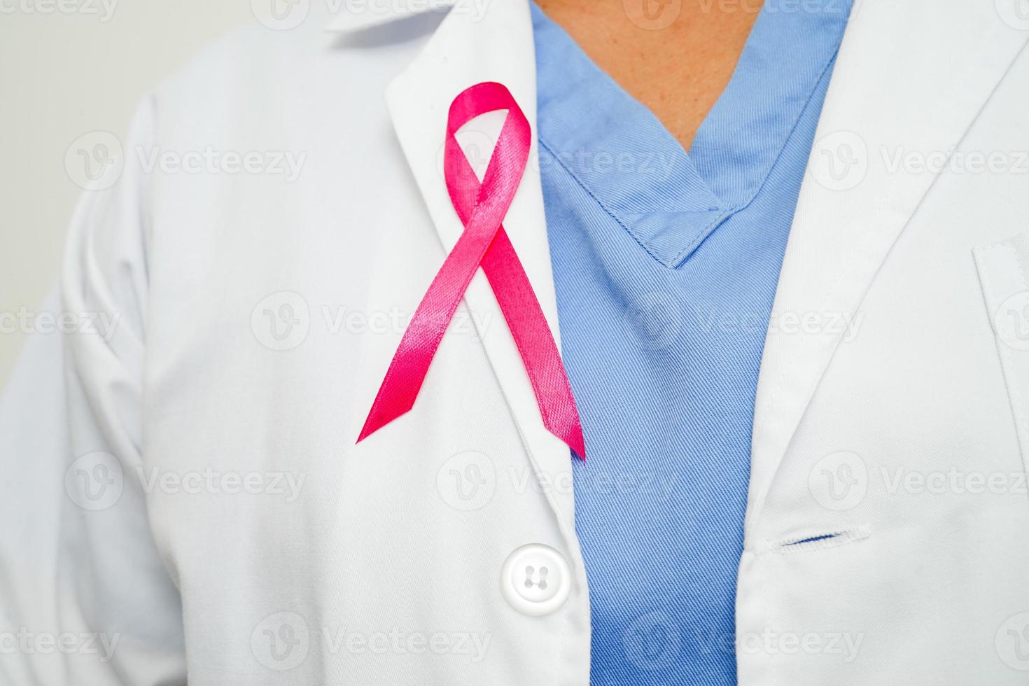 Asian woman doctor with pink ribbon, World Breast Cancer Day at October. photo