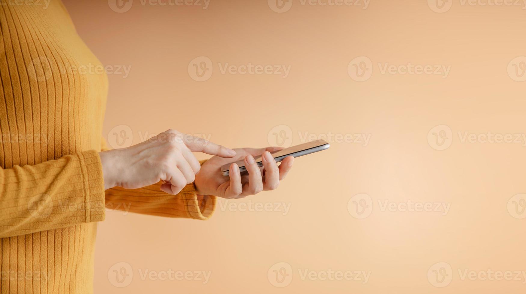 Closeup of Hand Using Mobile Phone. Cropped image. Selective Focus. Using Smartphone for Communication, Texting, Reading or Playing Game photo