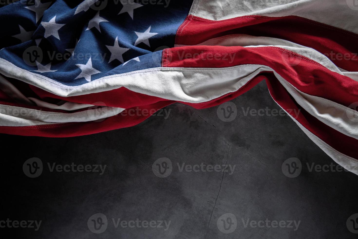 USA Flag Lying on Cement Background. American Symbolic. 4th of July or Memorial Day of United States. Copy Space for Text photo