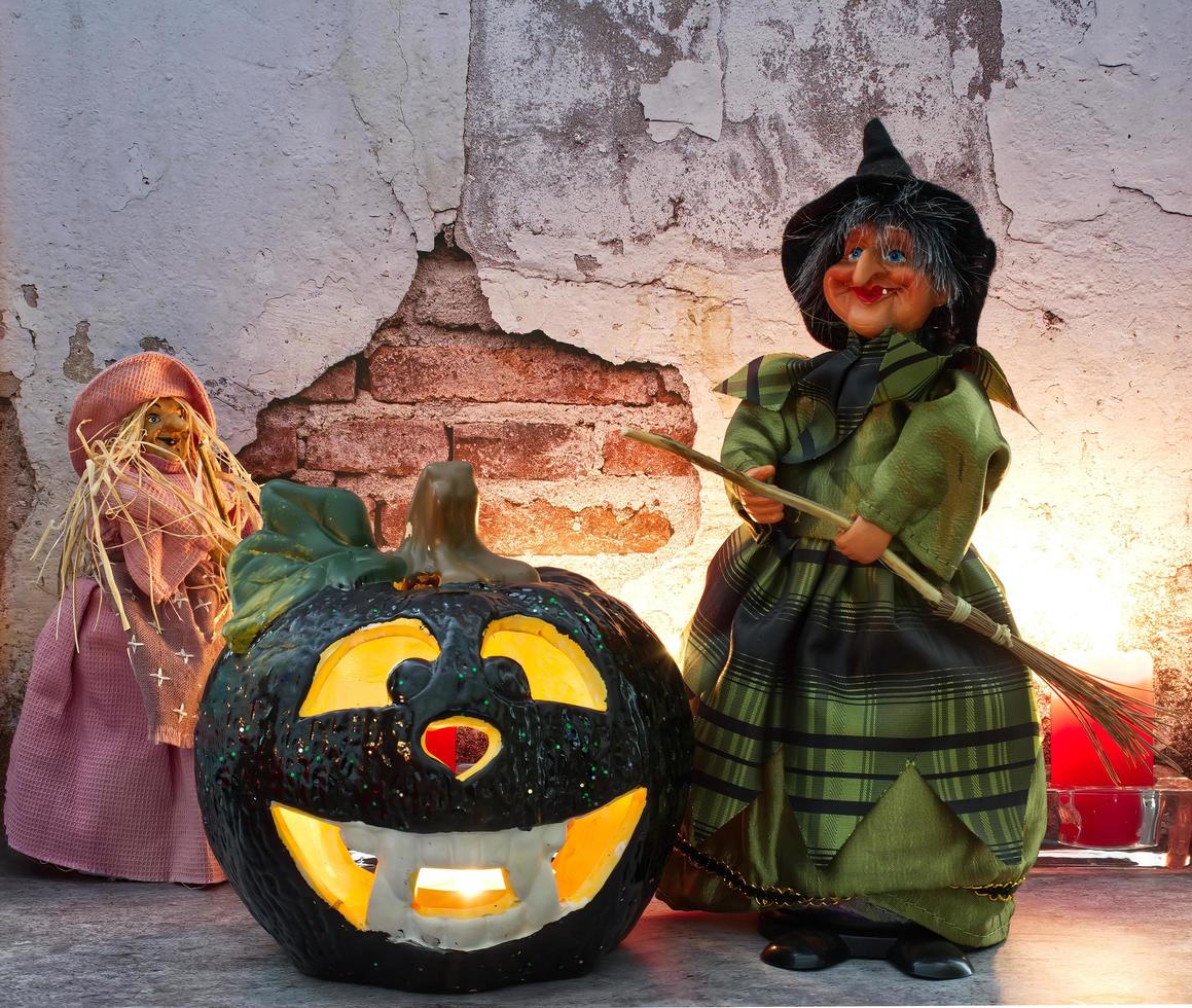 Halloween Witch in decorated dress holding a wooden broom. Trick or treat. Happy Halloween. photo