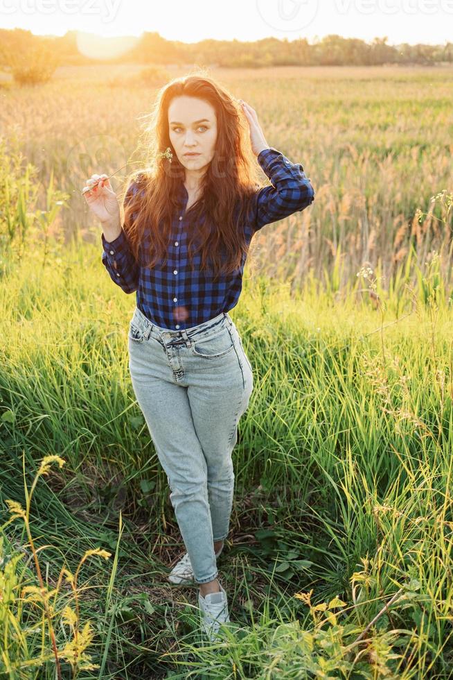 Portrait of a beautiful young woman on meadow photo