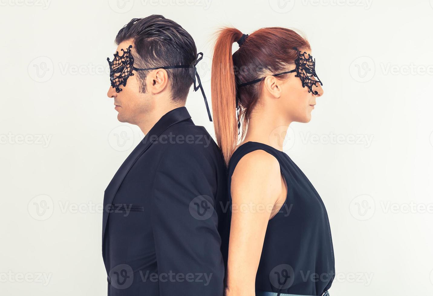 Side view of a couple standing back to back. photo