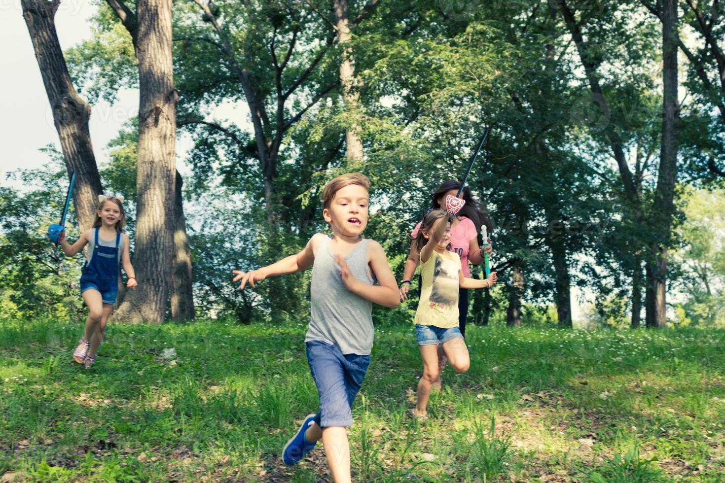 Playful  kids running in the park. photo