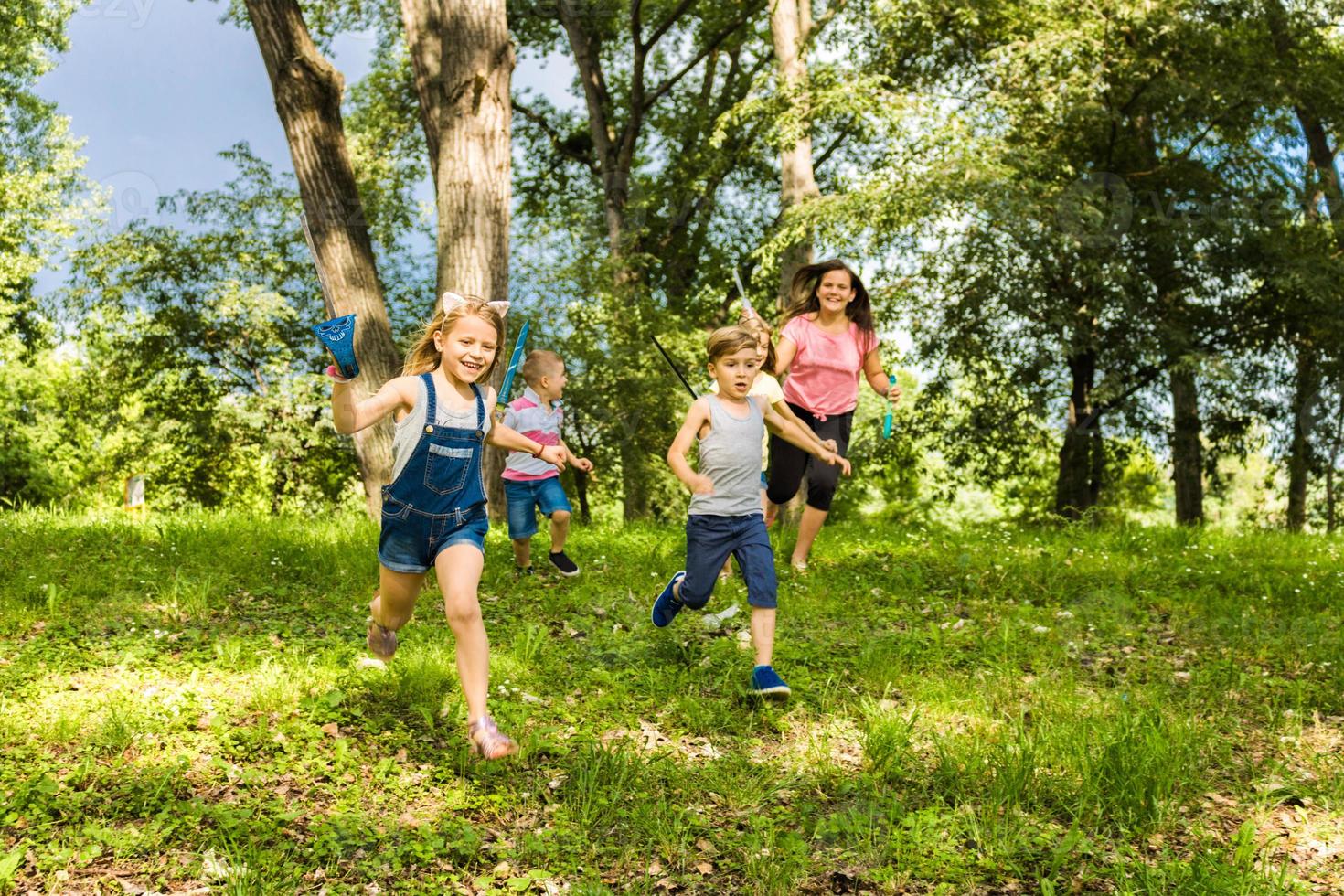 Happy kids running in the forest. photo