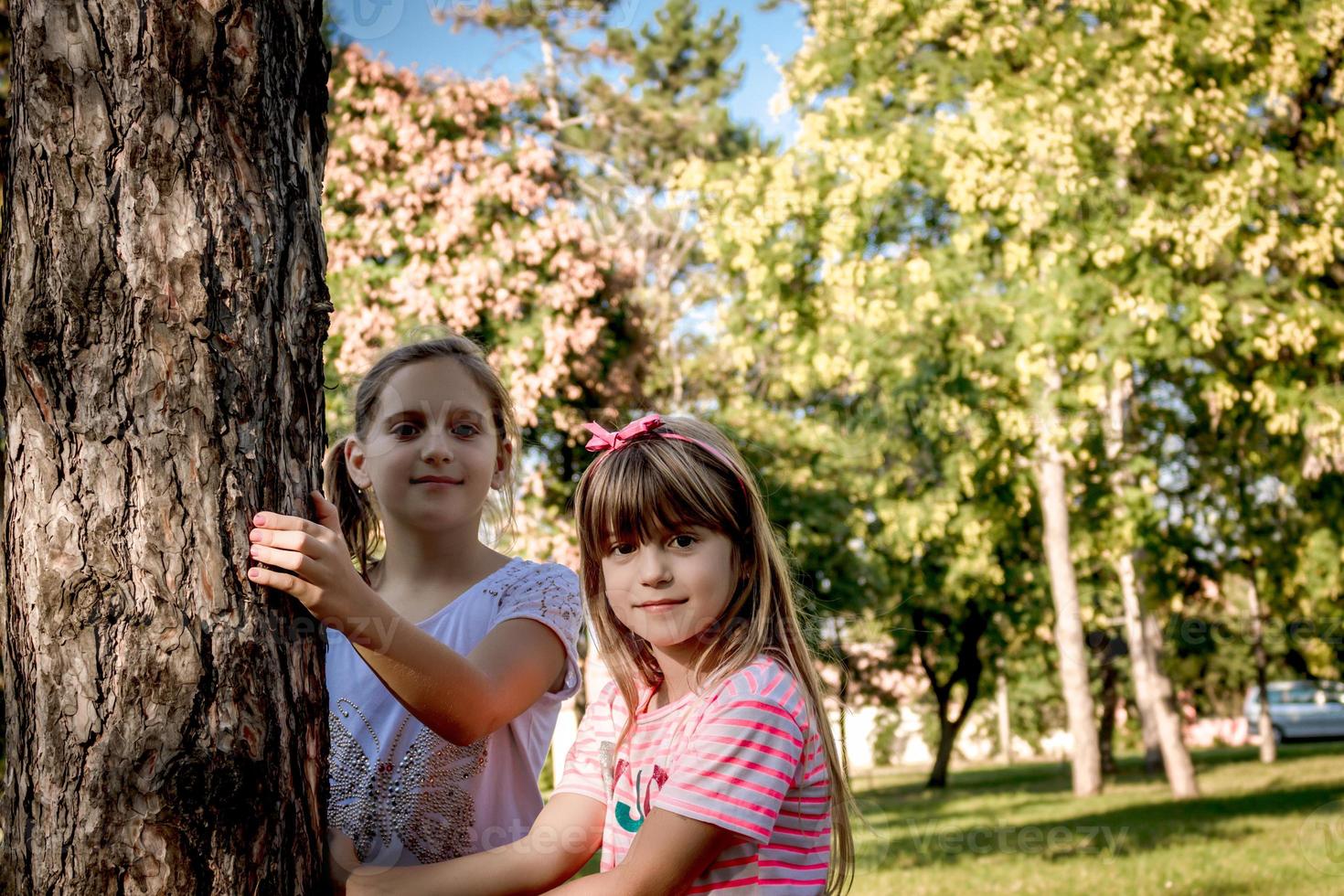 Two smiling girls in nature during spring day. photo