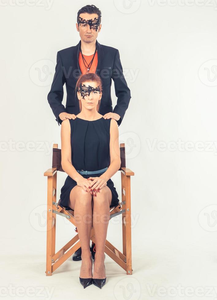 Serious couple wearing masks on their faces. photo