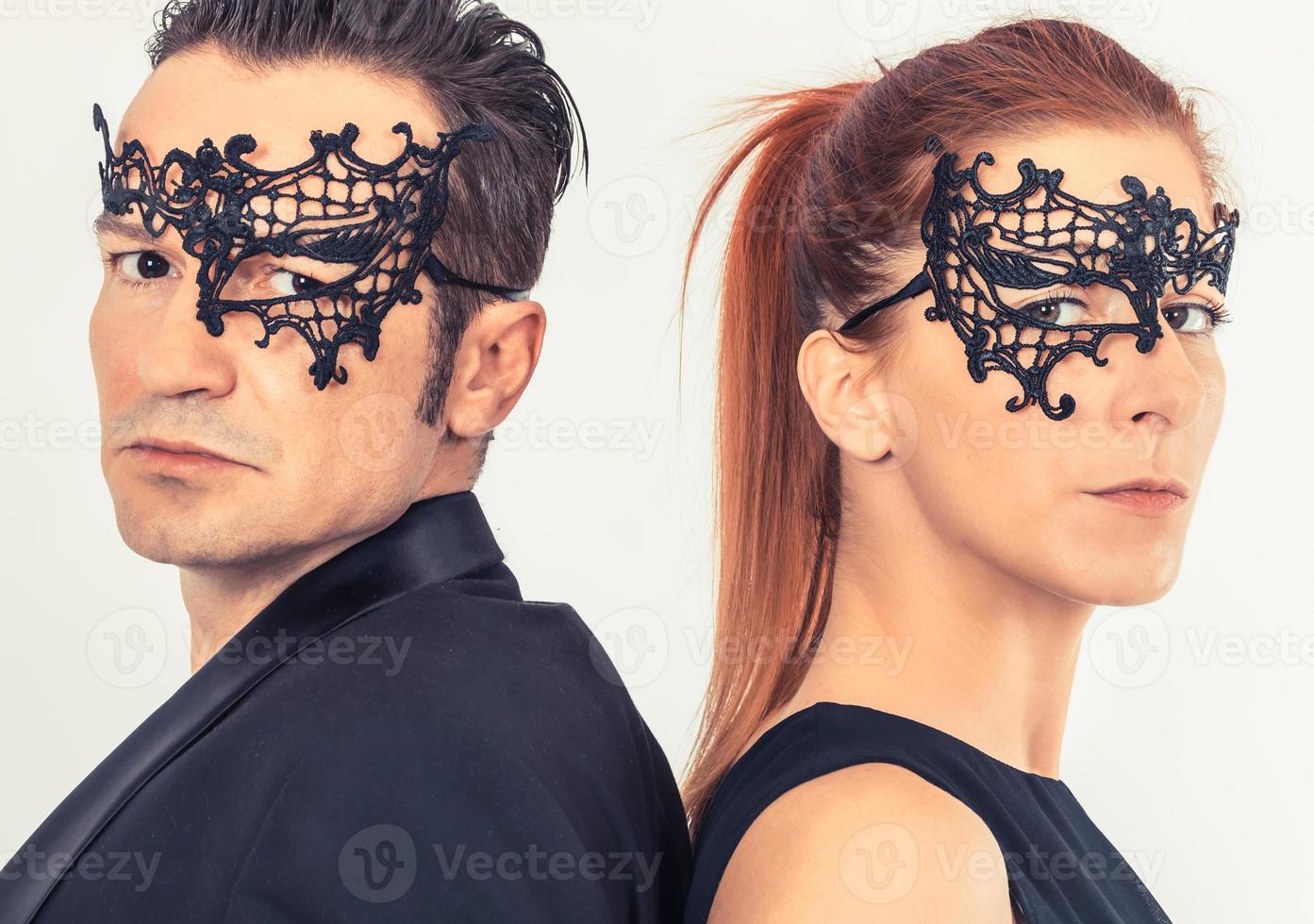 Couple with masks on their faces looking at camera. photo