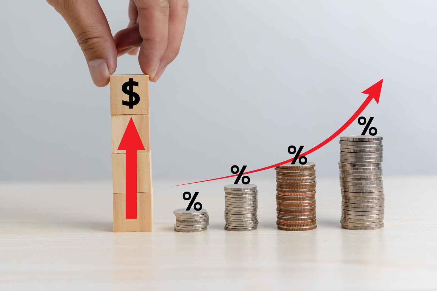 Business finance investments economy stack coin inflation and arrow red with wood cube percentage on desk. photo