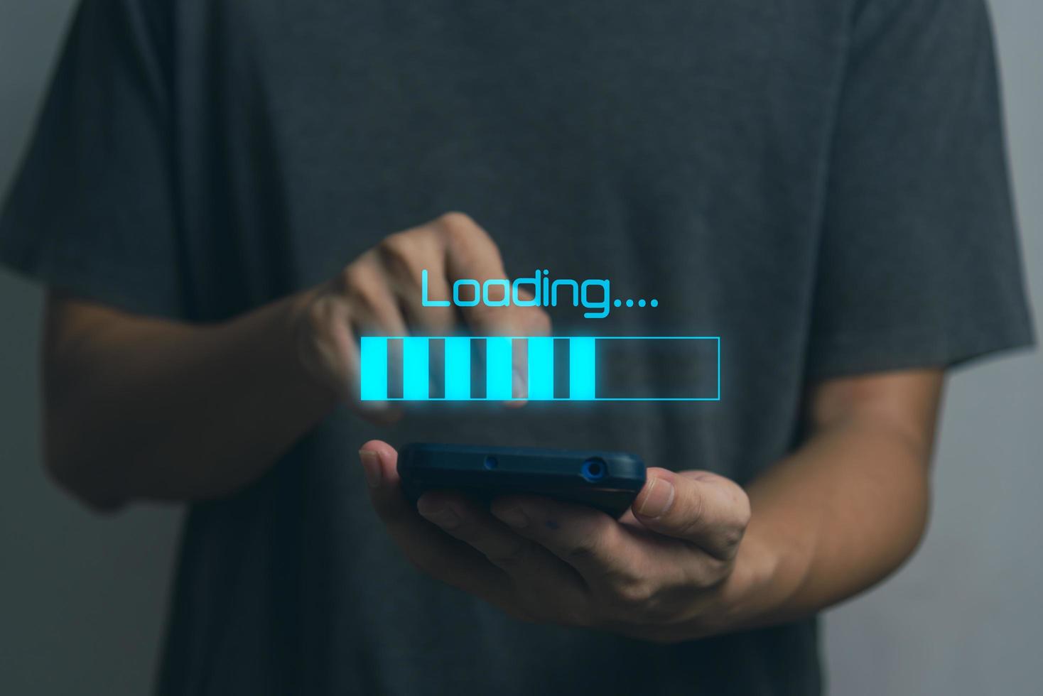 Man holding smart phone virtual screen loading digital internet online connect information system technology concept. photo