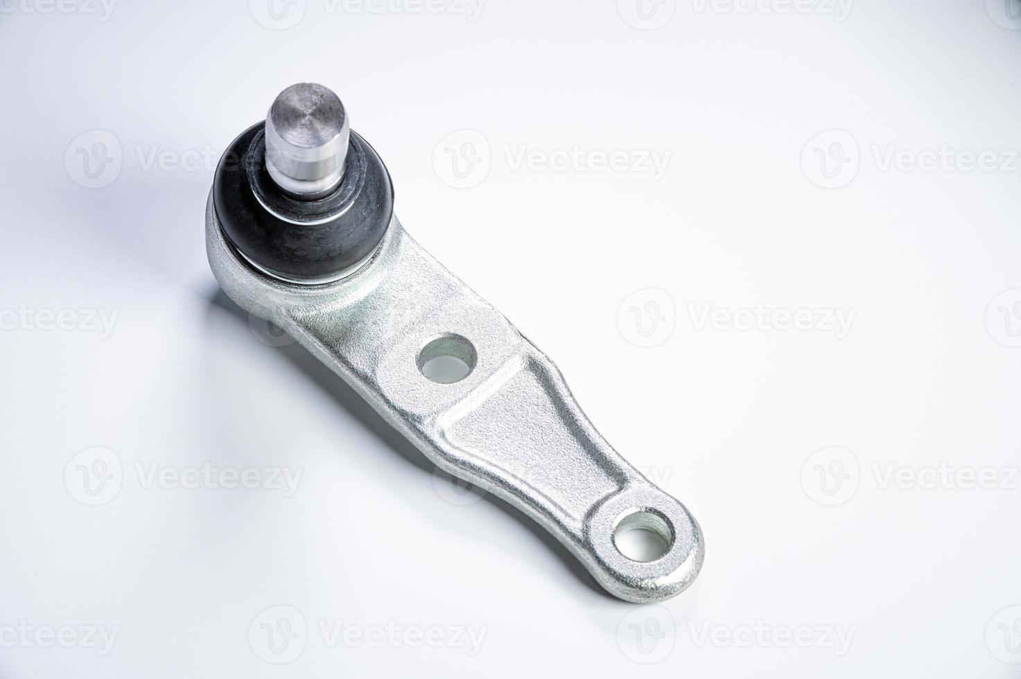 New spare parts spherical ball joints of a suspension bracket of a car on a gray background photo