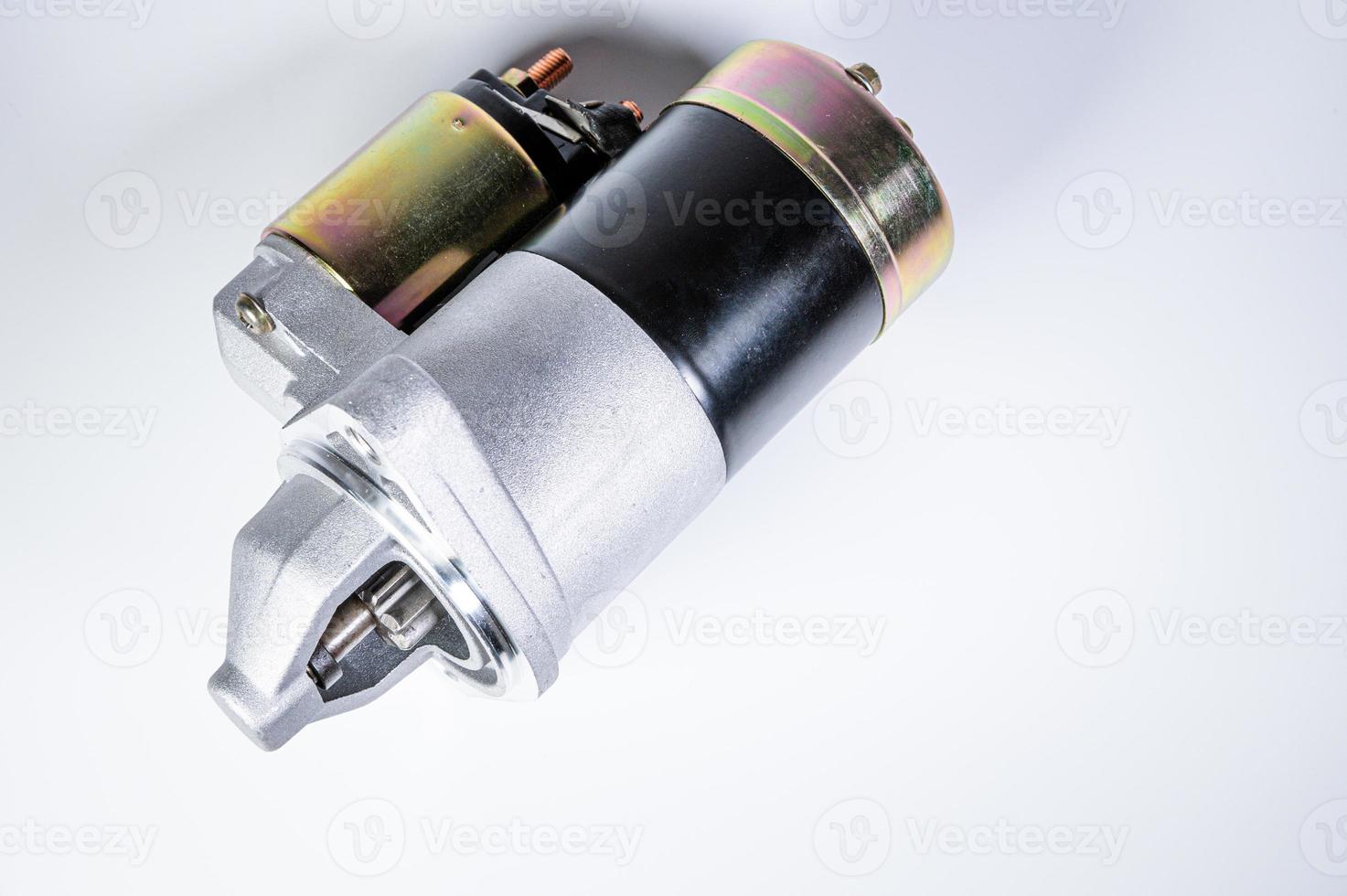 Starter of an internal combustion engine New Spare part for car on a gray background photo