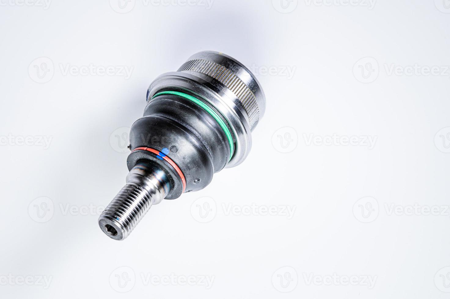 New spare parts spherical ball joints of a suspension bracket of a car on a gray background photo