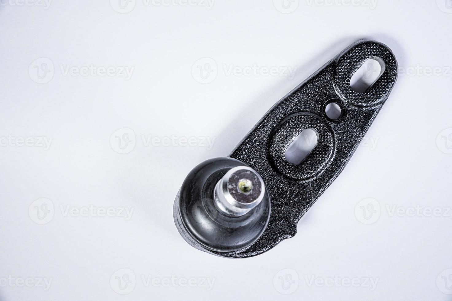 New spare parts spherical ball joints of a suspension bracket of a car on a gray background photo