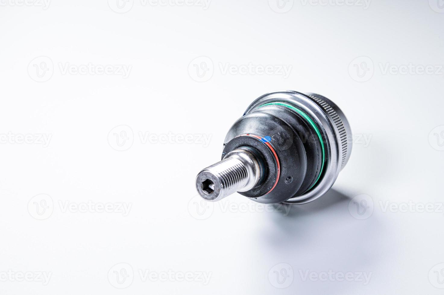 New spare parts spherical ball joints of a suspension bracket of a car on a gray background photo