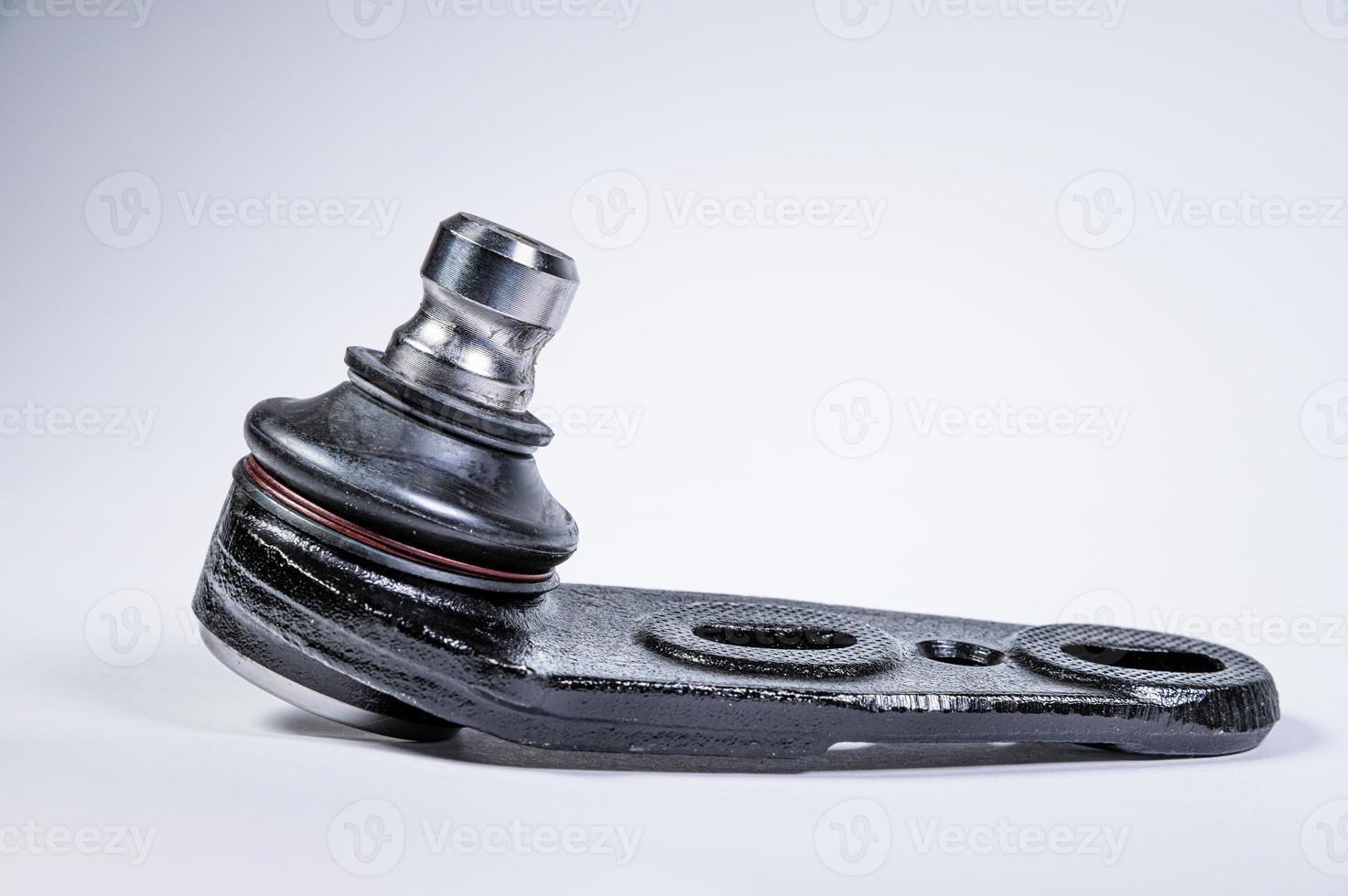 New spare parts spherical ball joints of a suspension bracket of a car on a gray background photo