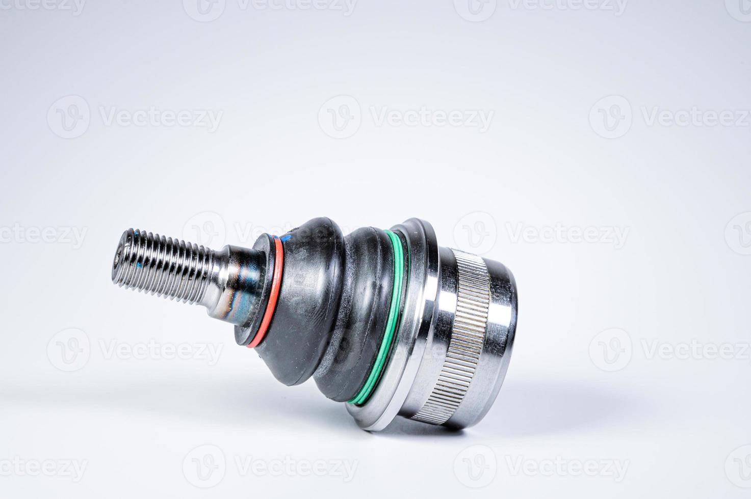 New spare parts spherical ball joints of a suspension bracket of a car on a gray background photo