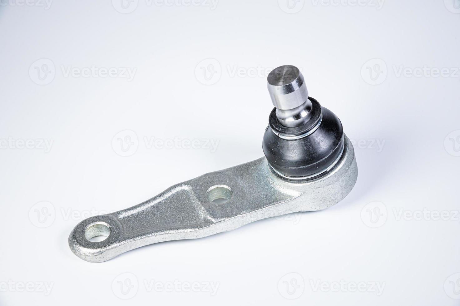 New spare parts spherical ball joints of a suspension bracket of a car on a gray background photo