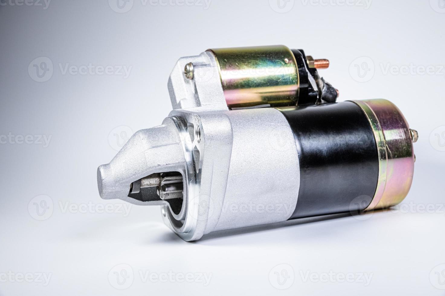 Starter of an internal combustion engine New Spare part for car on a gray background photo