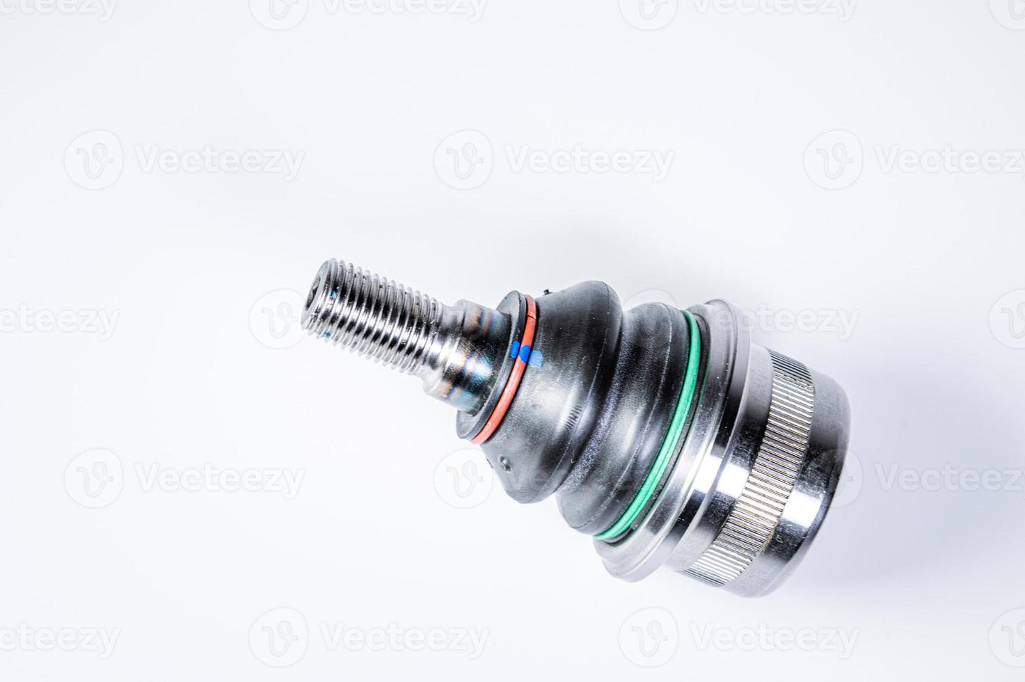 New spare parts spherical ball joints of a suspension bracket of a car on a gray background photo