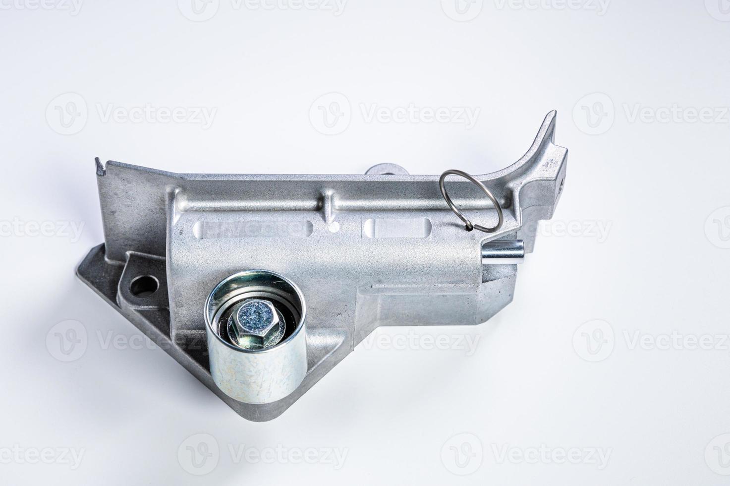Tension mechanism roller of a timing belt of an internal combustion engine on a gray background. The concept of new spare parts and maintenance of vehicles photo