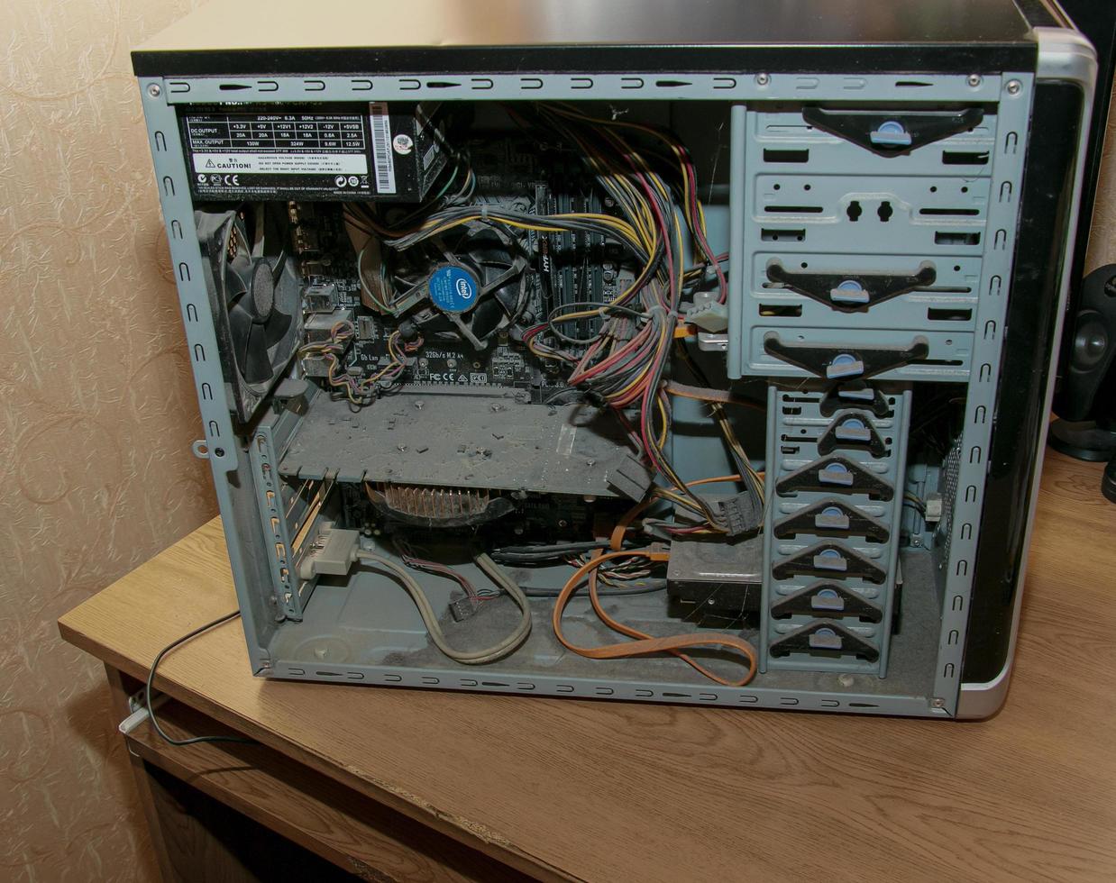 A thick layer of dust covers the internal electronic components of the old computer, Thick dust on the electronic components it is nasty, close up. photo