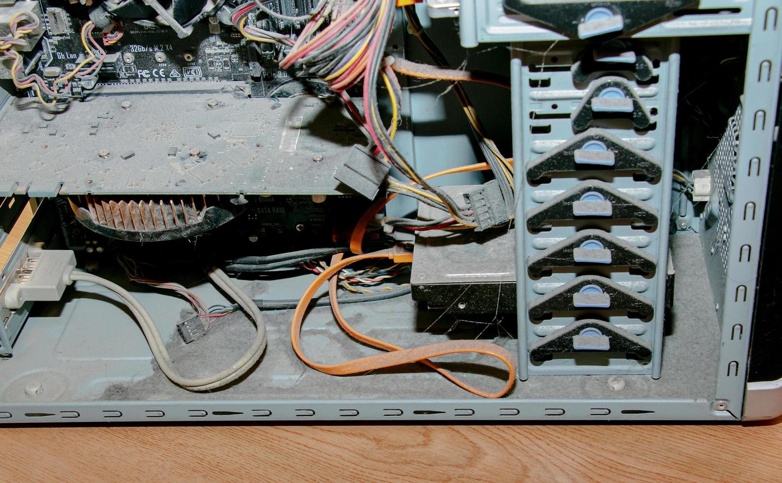 A thick layer of dust covers the internal electronic components of the old computer, Thick dust on the electronic components it is nasty, close up photo