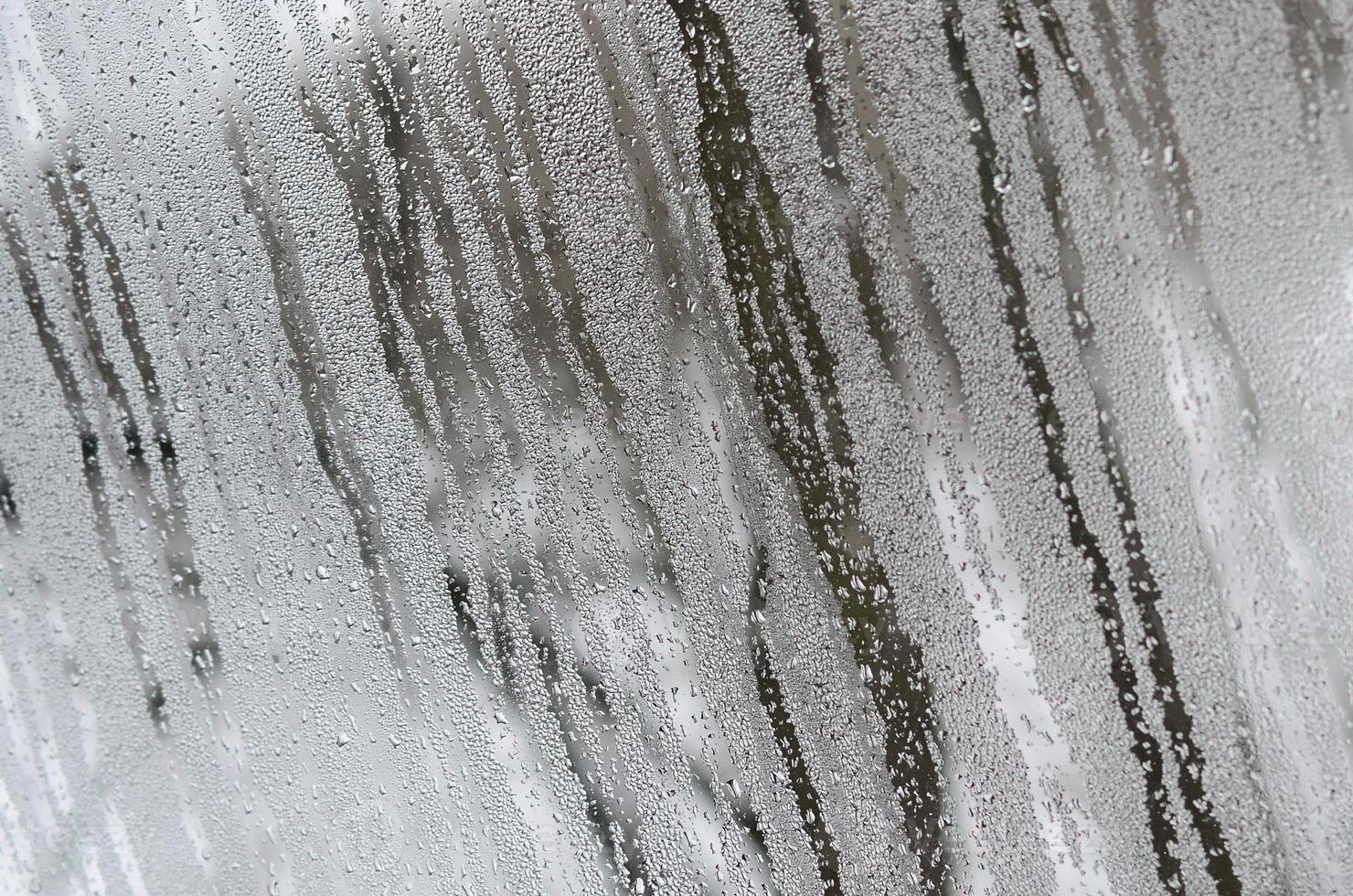 The texture of a misted glass with a lot of drops and condensation flows. Background image photo
