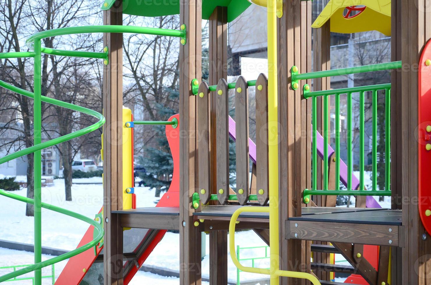 Fragment of a playground made of plastic and wood, painted in different colors photo
