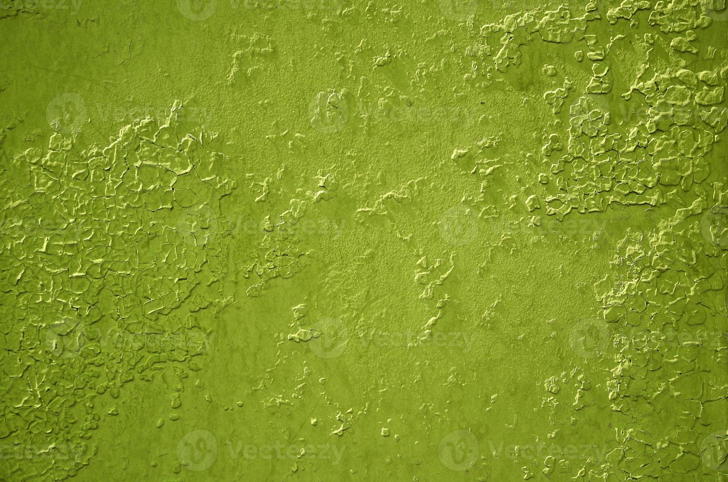 Texture of a metal wall with an old paint coating that spoils under the influence of time and weather photo