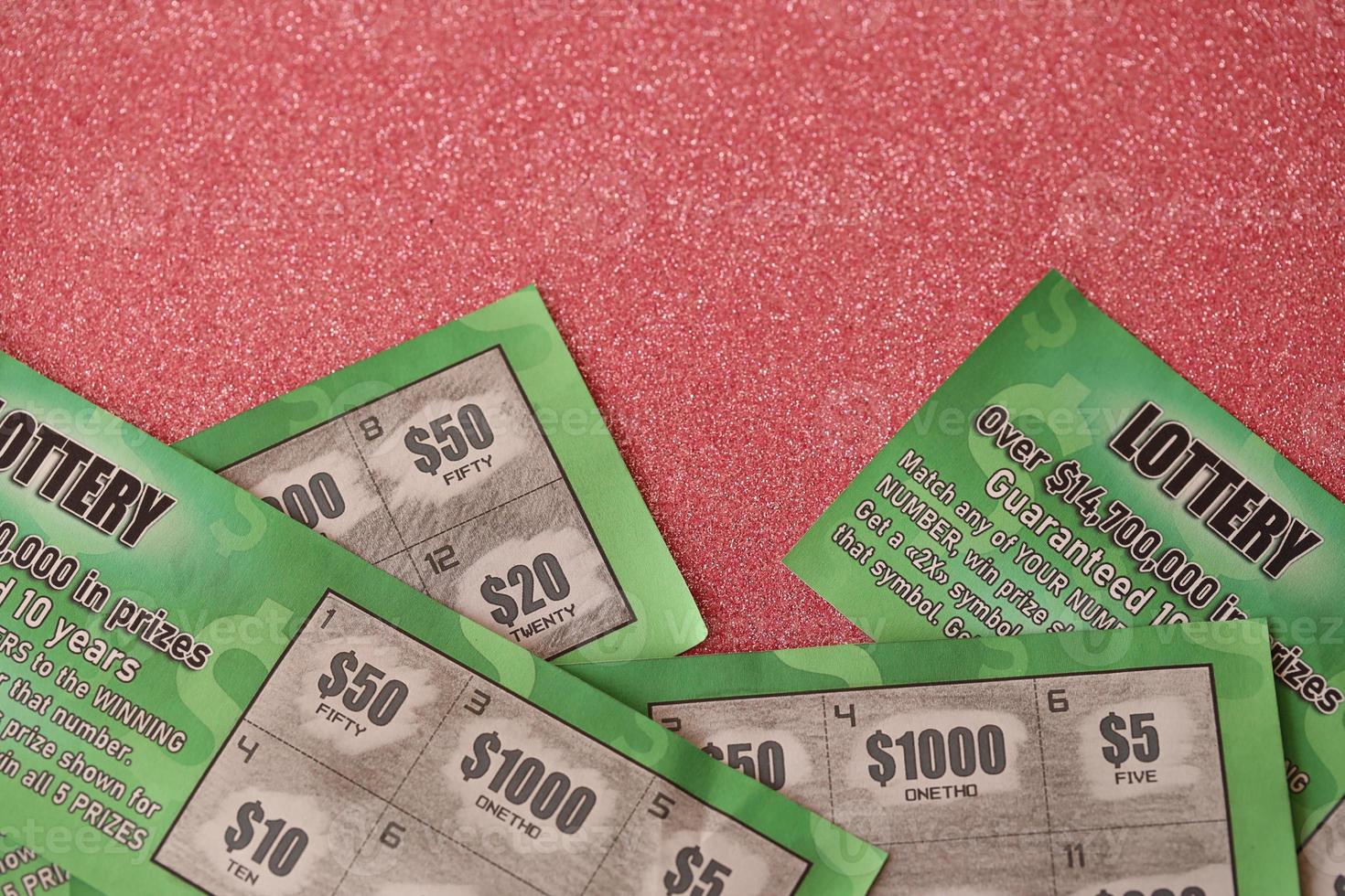 Close up view of green lottery scratch cards. Many used fake instant lottery tickets with gambling results. Gambling addiction photo