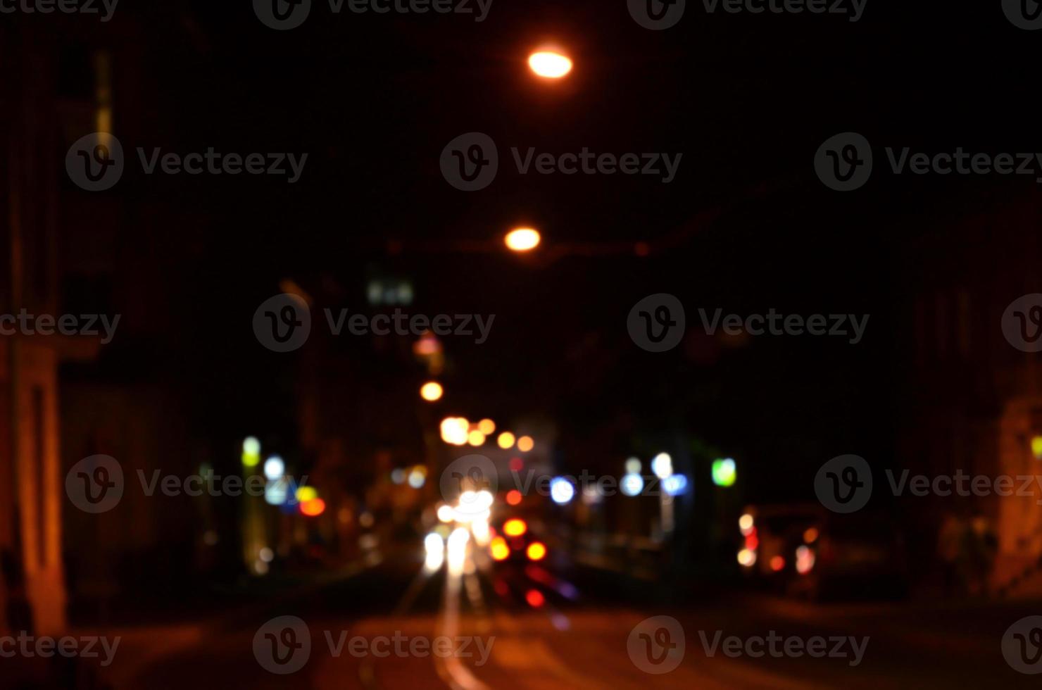 Blurred night scene of traffic on the roadway. Defocused image of cars traveling with luminous headlights. Bokeh Art photo