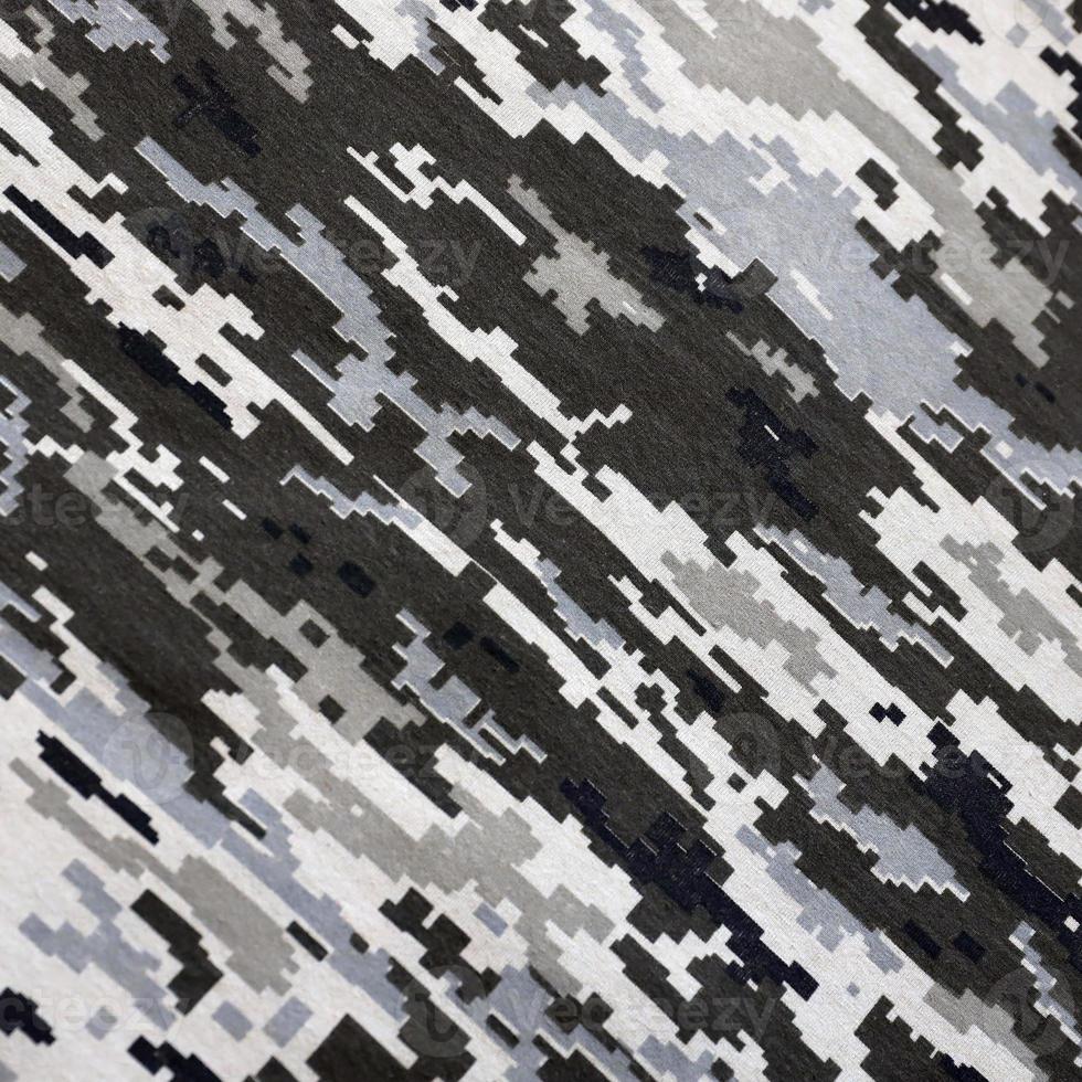 Fabric with texture of Ukrainian military pixeled camouflage. Cloth with camo pattern in grey, brown and green pixel shapes. Official uniform of Ukrainian soldiers photo