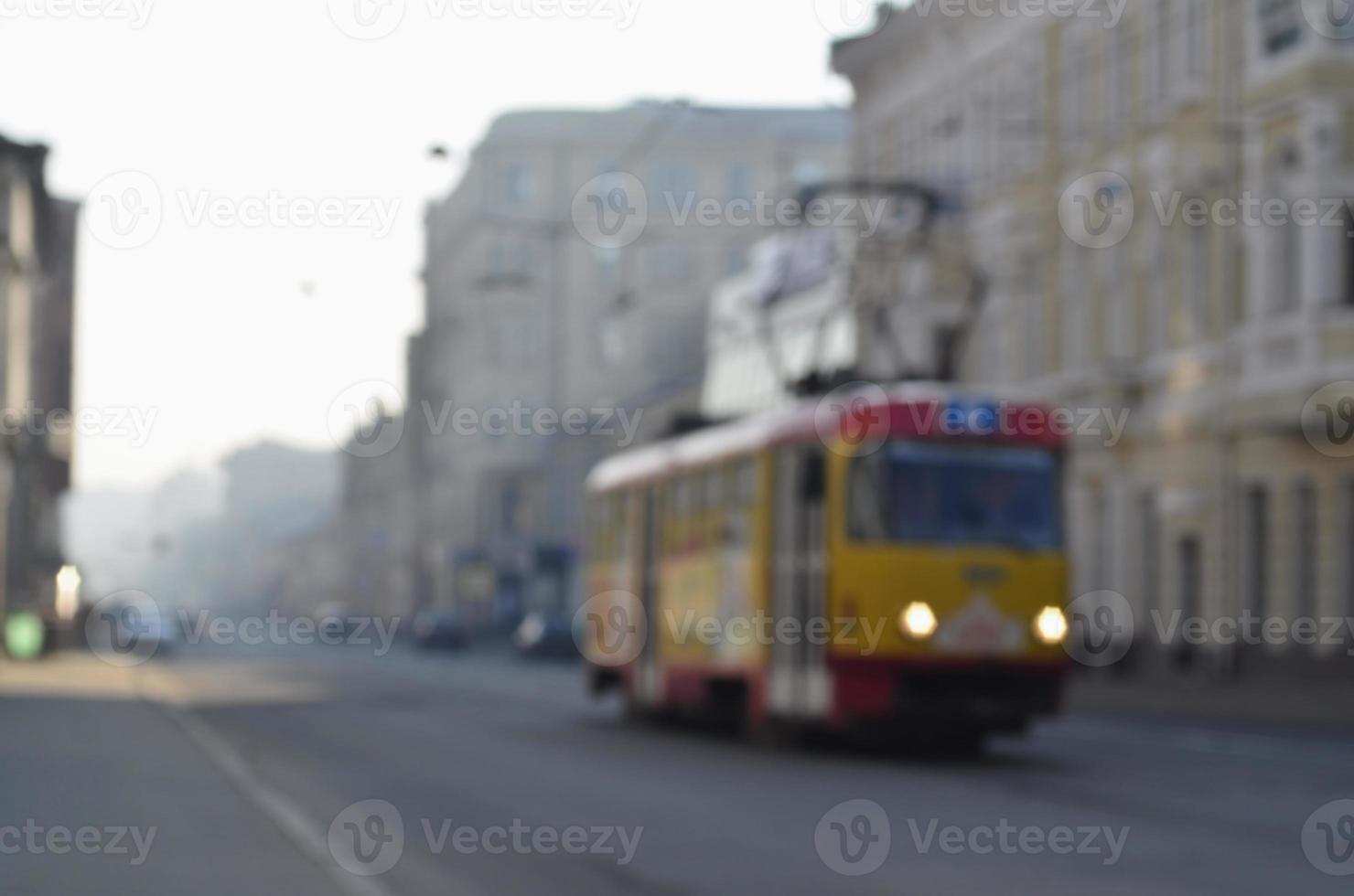 Blurred landscape of highway with cars and tram in foggy morning photo