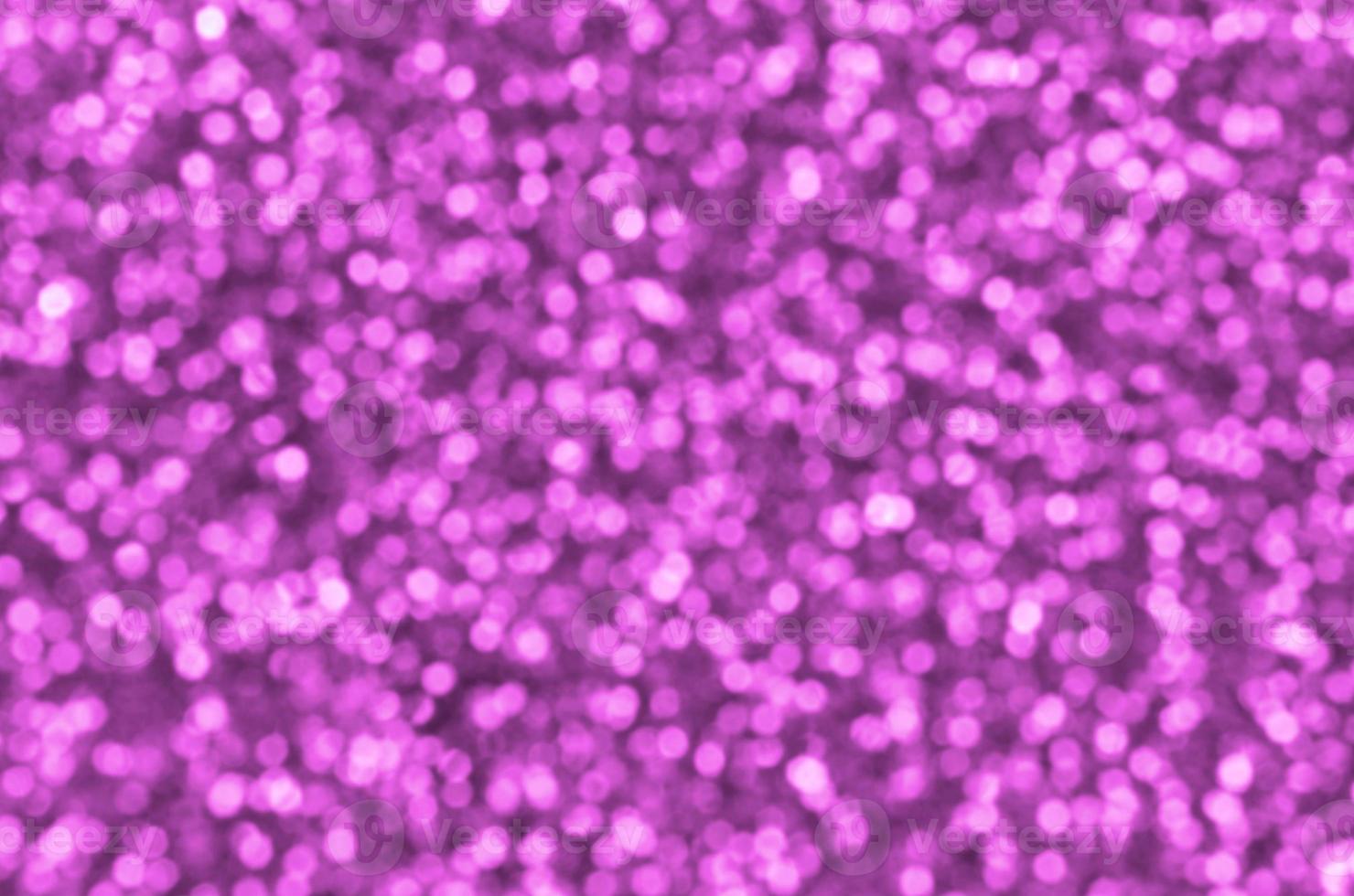 Blurred pink decorative sequins. Background image with shiny bokeh lights from small elements photo