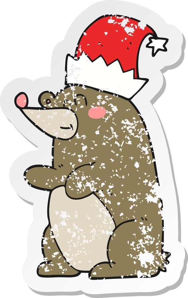 retro distressed sticker of a cartoon bear wearing christmas hat vector