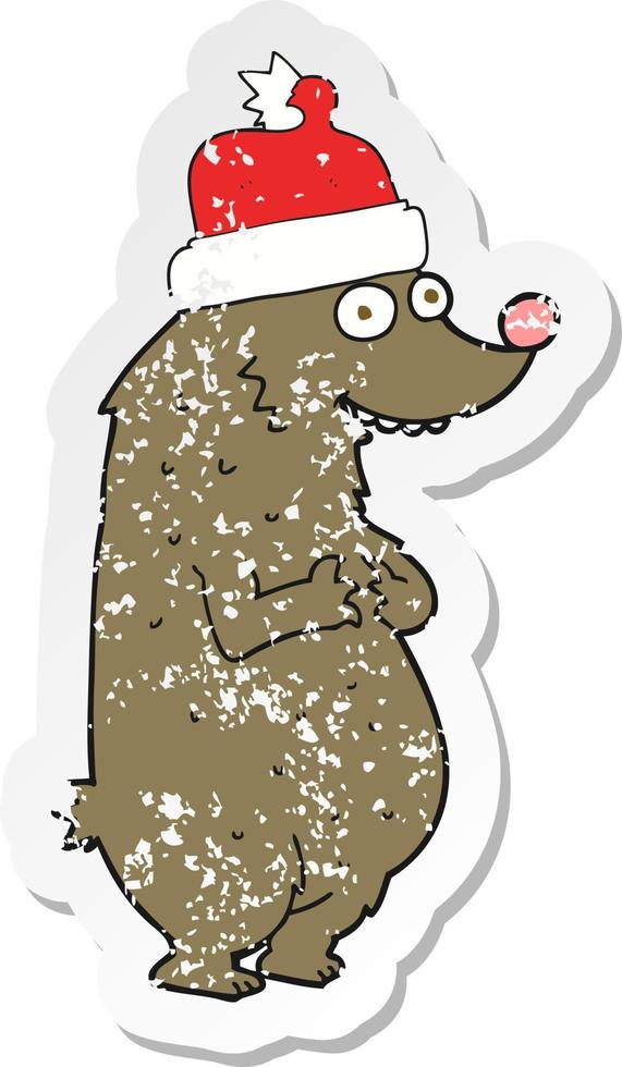 retro distressed sticker of a cartoon bear wearing christmas hat vector