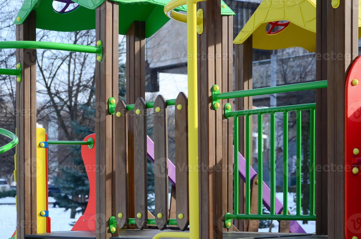 Fragment of a playground made of plastic and wood, painted in different colors photo