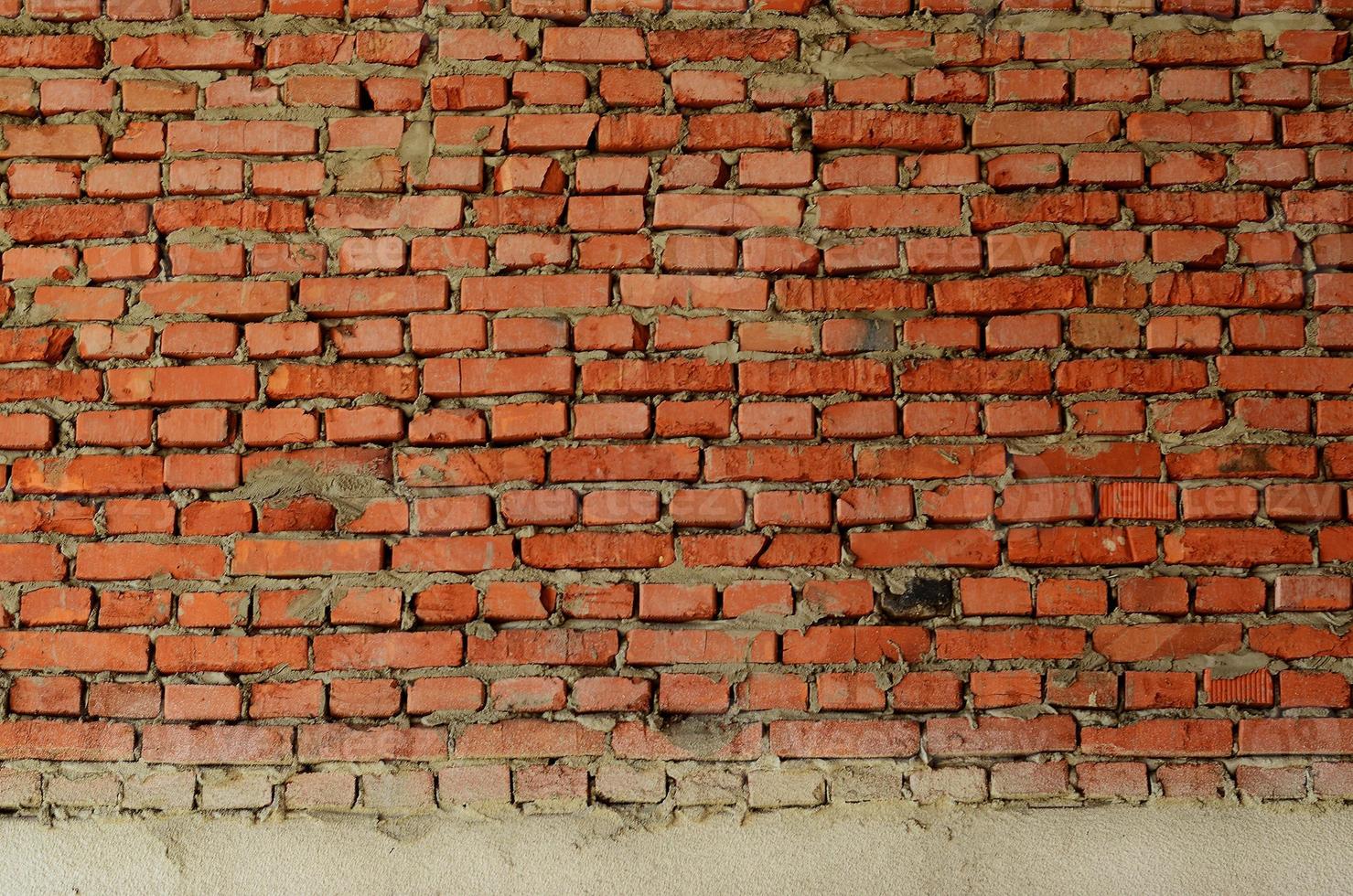 Red brick wall texture grunge background with many rows of bricks, may use to interior design photo