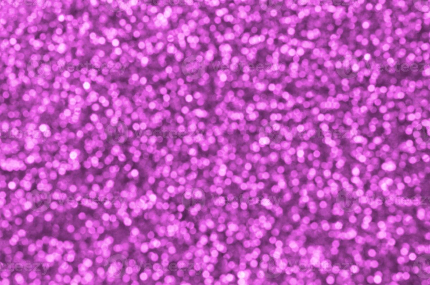 Blurred pink decorative sequins. Background image with shiny bokeh lights from small elements photo