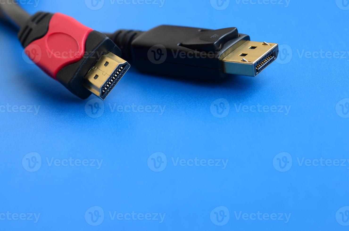 Audio video HDMI computer cable plug and 20-pin male DisplayPort gold plated connector for a flawless connection on a blue background photo