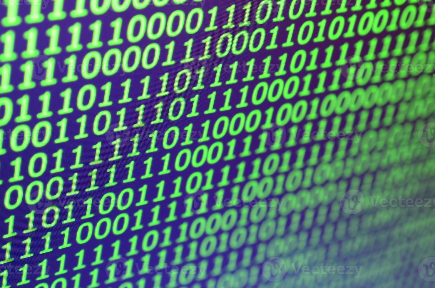 Macro shot of binary code on the monitor of an office computer. The concept of the programmer's work. The flow of digital information strings photo