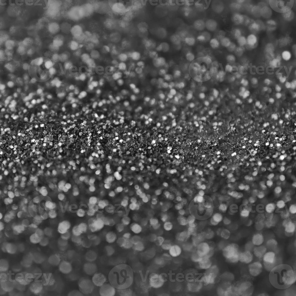 Silver decorative sequins. Background image with shiny bokeh lights from small elements photo