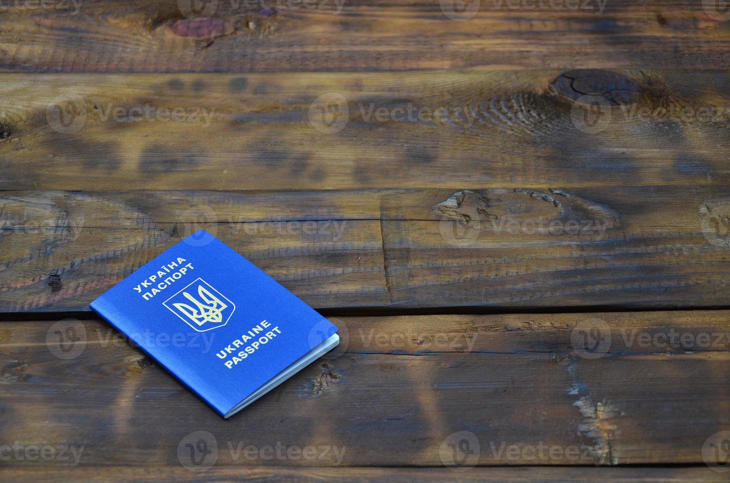 Photo of the Ukrainian foreign passport, lying on a dark wooden surface. The concept of introducing visa-free travel for Ukrainian citizens