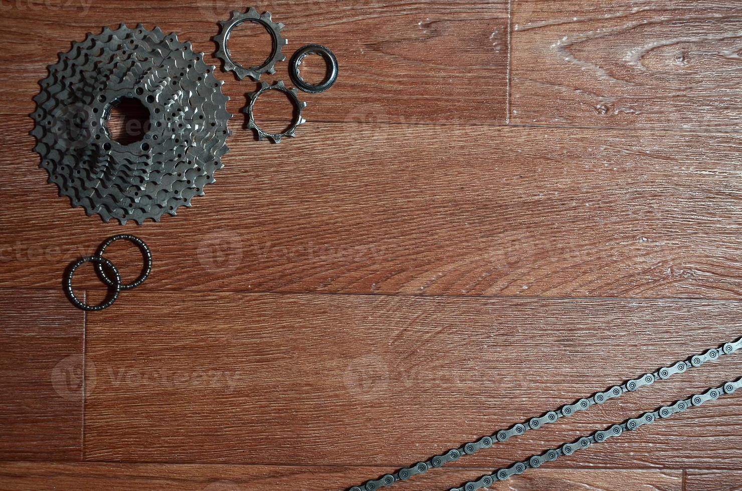 Some composition of a bicycle chain, several sprockets and other components of a sports bike photo