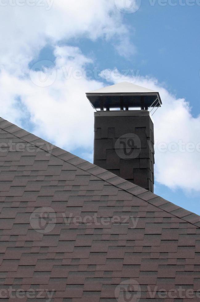 The roof covered with a modern flat bituminous waterproof coating under a blue sky photo