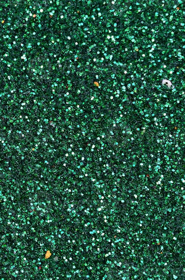 Colorful defocused emerald green background with glittering and sparkling spots photo