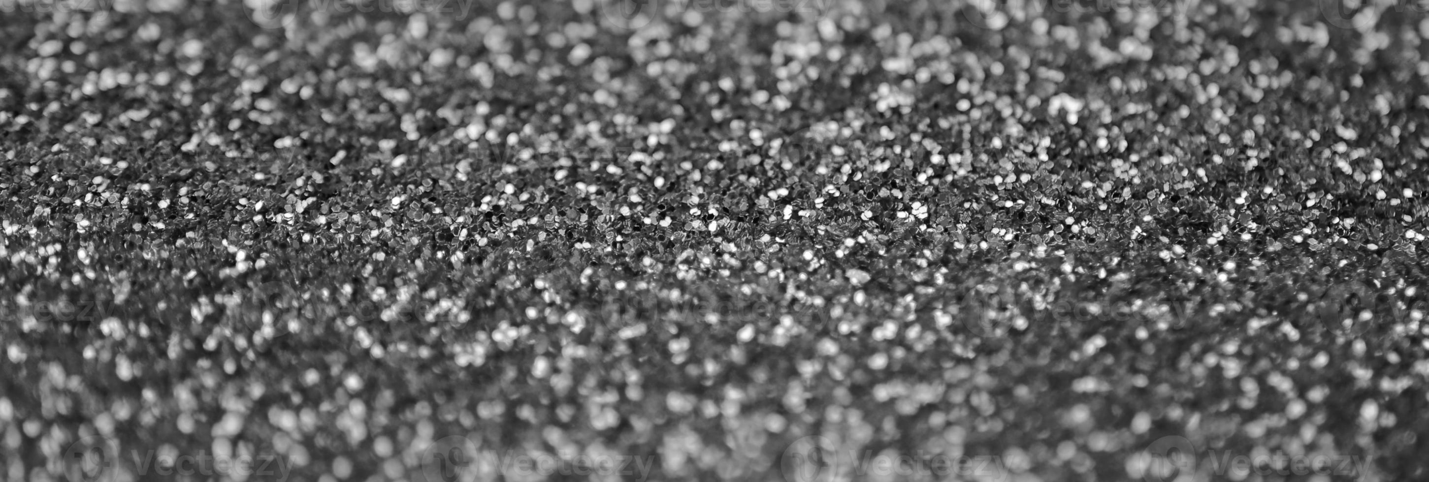 Silver decorative sequins. Background image with shiny bokeh lights from small elements photo