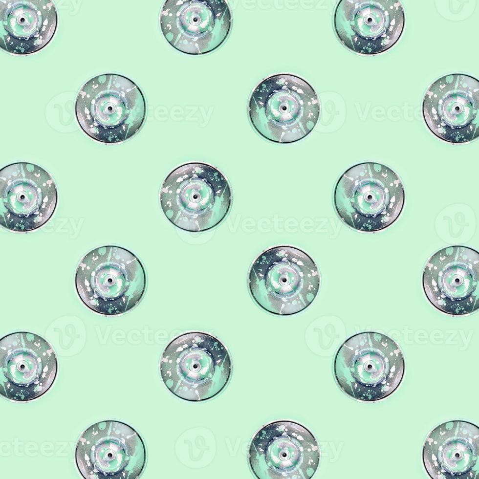 Many used spray cans for graffiti drawing lies on a pastel colored backgroung. Street art painting concept. Minimal flat lay pattern. Top view photo