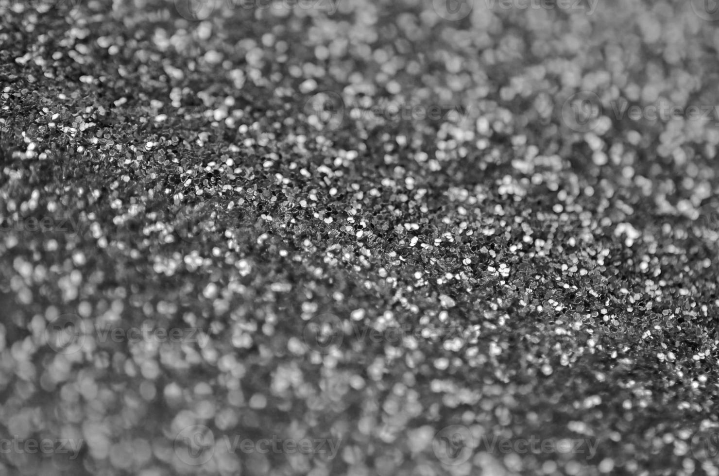 Silver decorative sequins. Background image with shiny bokeh lights from small elements photo